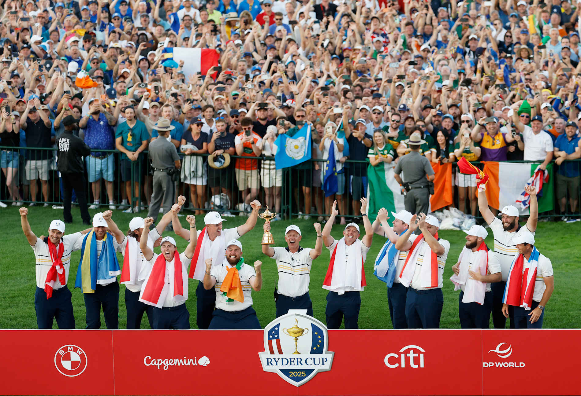 FARMINGDALE, NEW YORK - SEPTEMBER 28: Captain Luke Donald of Team Europe holds the Ryder Cup trophy as Team Europe celebrates their 15-13 win over Team America during the trophy presentation ceremony during the Sunday singles matches of the 2025 Ryder Cup at Black Course at Bethpage State Park Golf Course on September 28, 2025 in Farmingdale, New York. (Photo by Harry How/Getty Images)
