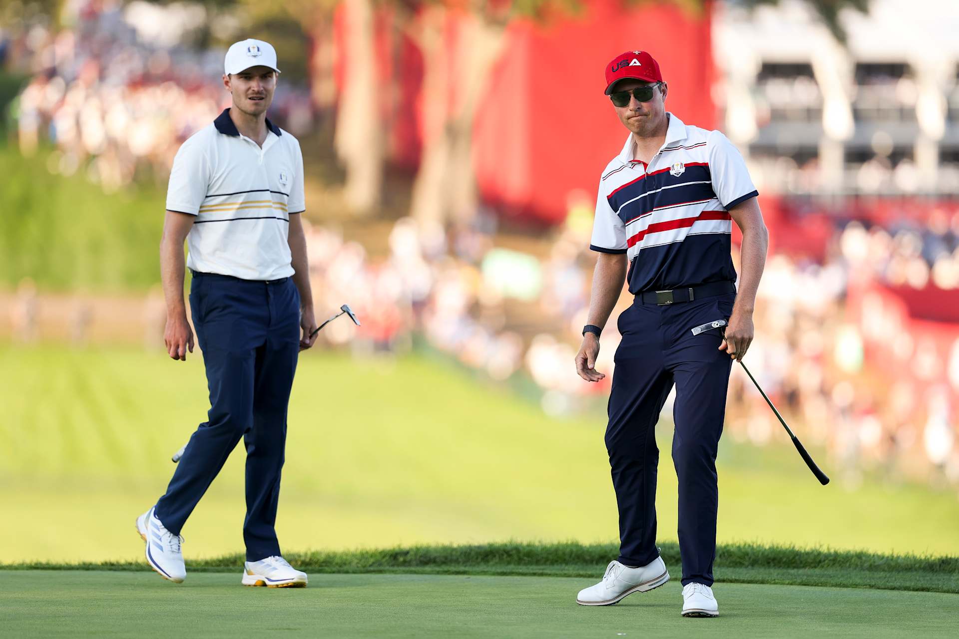 FARMINGDALE, NEW YORK - SEPTEMBER 28: (L-R) Rasmus Hojgaard of Team Europe and Ben Griffin of Team United States react on the 18th green during the Sunday singles matches of the 2025 Ryder Cup at Black Course at Bethpage State Park Golf Course on September 28, 2025 in Farmingdale, New York. (Photo by Richard Heathcote/Getty Images)