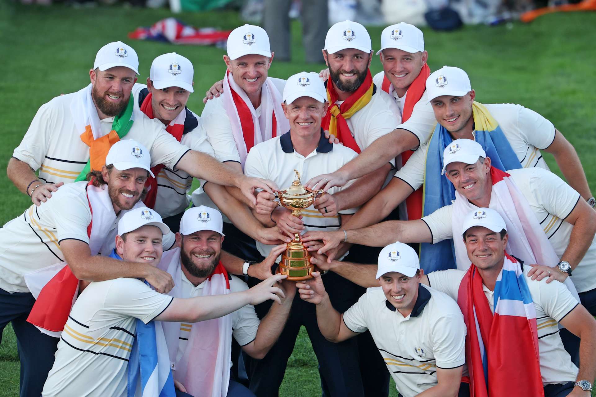 FARMINGDALE, NEW YORK - SEPTEMBER 28: Captain Luke Donald, Shane Lowry, Rasmus Hojgaard, Justin Rose, Jon Rahm, Sepp Straka, Ludvig Aberg, Rory McIlroy, Viktor Hovland, Matt Fitzpatrick, Tommy Fleetwood, Robert MacIntyre and Tyrrell Hatton of Team Europe hold the Ryder Cup trophy after their 15-13 win over Team United States during the Sunday singles matches of the 2025 Ryder Cup at Black Course at Bethpage State Park Golf Course on September 28, 2025 in Farmingdale, New York. (Photo by Jamie Squire/Getty Images)